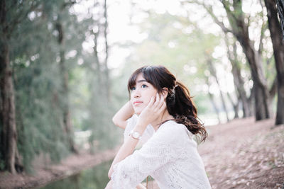 Portrait of young woman in forest