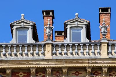 Low angle view of building against clear blue sky