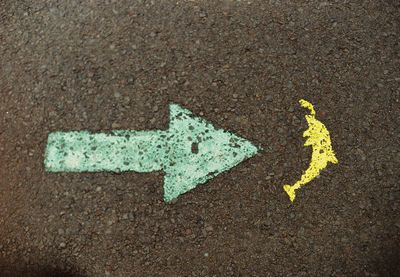High angle view of arrow sign on road