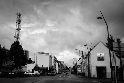 Street amidst buildings in city against sky