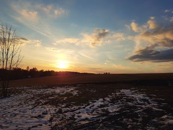 Scenic view of field against sky during sunset