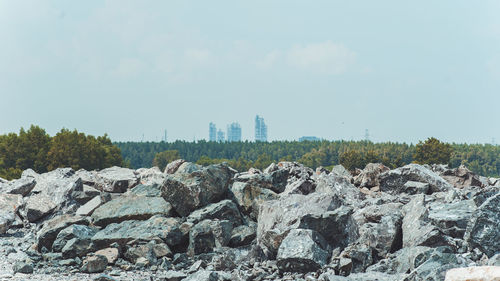 Panoramic view of rocks and buildings against sky