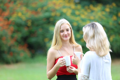 Portrait of a smiling young woman standing outdoors