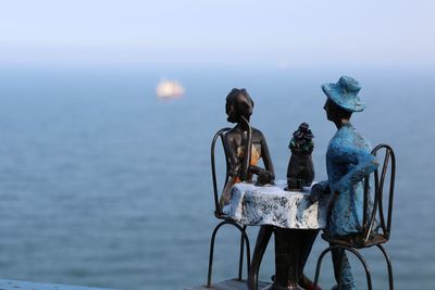 Close-up of figurines by sea