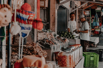 Group of people at market stall