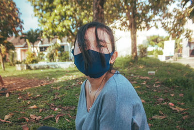 A woman with mask on the garden