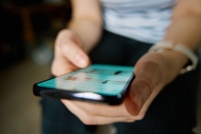 Midsection of woman using mobile phone