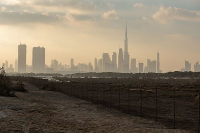 View of buildings in city at sunset