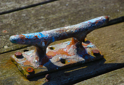 High angle view of rusty metal on wood