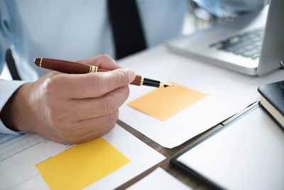 Close-up of hand holding paper