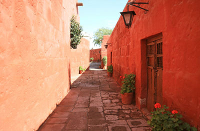 Cobblestone path among red and orange buildings in the monastery of santa catalina, arequipa, peru