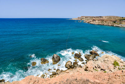 Scenic view of sea against clear blue sky