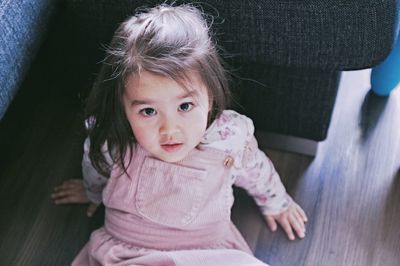 Portrait of cute girl sitting at home