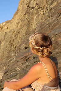 Rear view of woman on rock