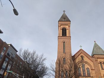 Low angle view of building and trees against sky