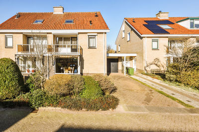 Empty road amidst houses