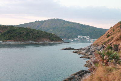 Scenic view of sea and mountains against sky