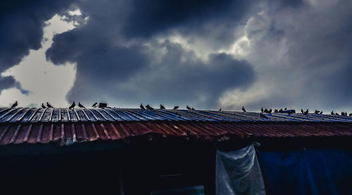 Low angle view of house roof against sky