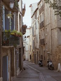 Street amidst houses against sky in city