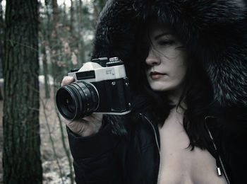 Close-up of woman photographing with camera