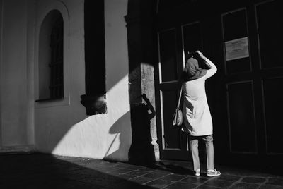 Rear view of women standing in corridor