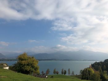 Scenic view of lake and mountains against sky