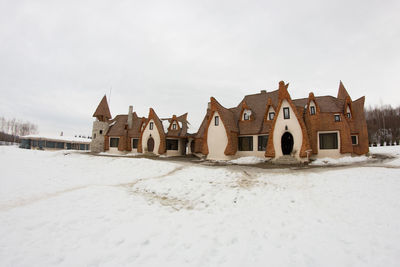 Houses against sky during winter