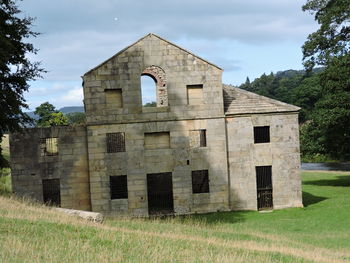 Historic building on field against sky