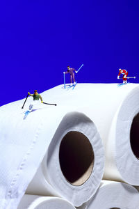 Close-up of coffee cup on table against clear blue sky