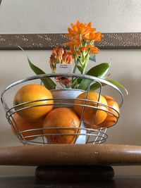 Close-up of orange flower vase on table