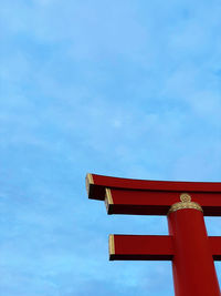 Low angle view of red building against blue sky