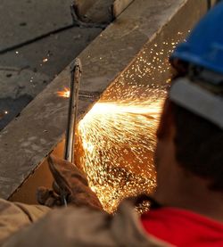 Blurred motion of man working on metal