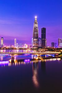 Illuminated buildings against sky at night