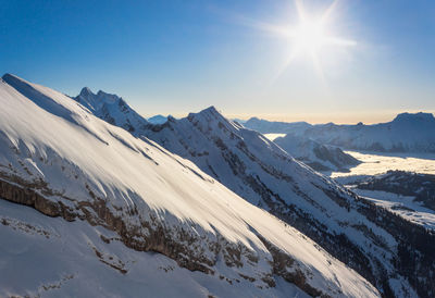 Scenic view of snow covered mountains against sky