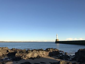 Scenic view of sea against clear blue sky