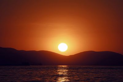 Scenic view of sea against romantic sky at sunset