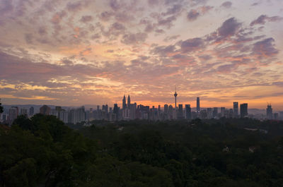 View of buildings against cloudy sky during sunset