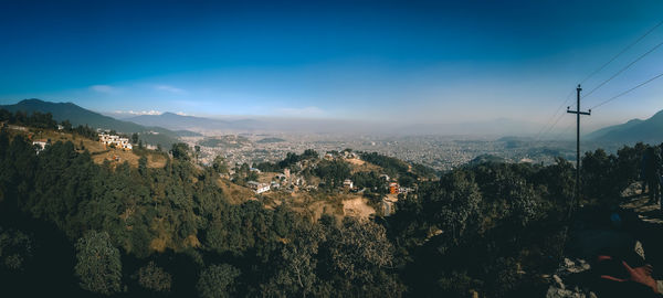 Scenic view of mountains against blue sky