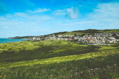 Scenic view of landscape and buildings against sky