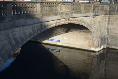 Arch bridge over river in city