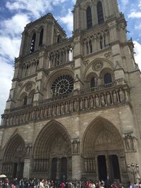 People outside cathedral against sky