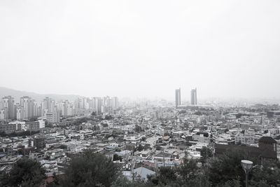 High angle view of buildings in city against clear sky