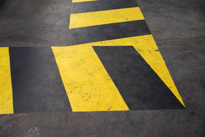High angle view of arrow sign on road