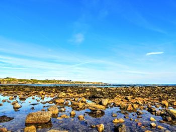 Scenic view of land against blue sky