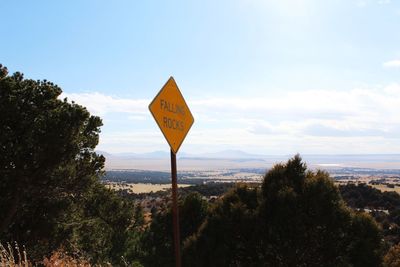 Information sign on landscape against sky