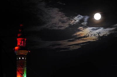 Illuminated building against sky at night