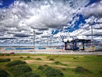 Train on grass against sky