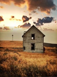Abandoned house against sky during sunset
