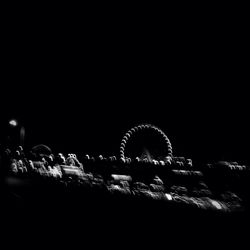 Illuminated ferris wheel at night