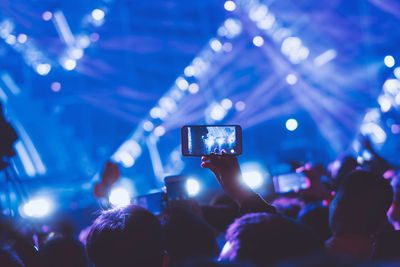 People photographing at music concert